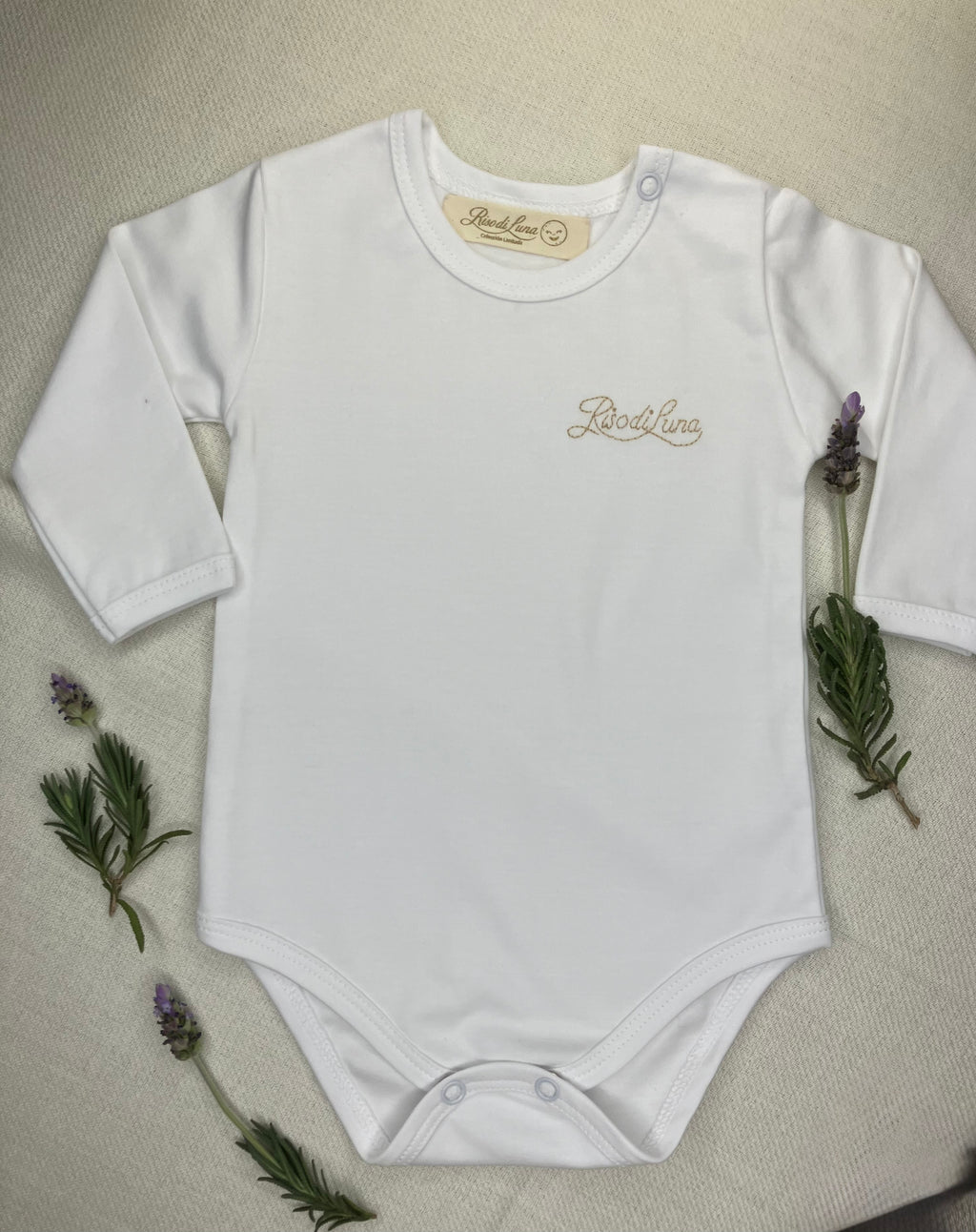 Body Riso di Luna en 100% algodón pima blanco, bordado a mano con hilos de algodón. Suave, hipoalergénico y artesanal, ideal para bebés recién nacidos.